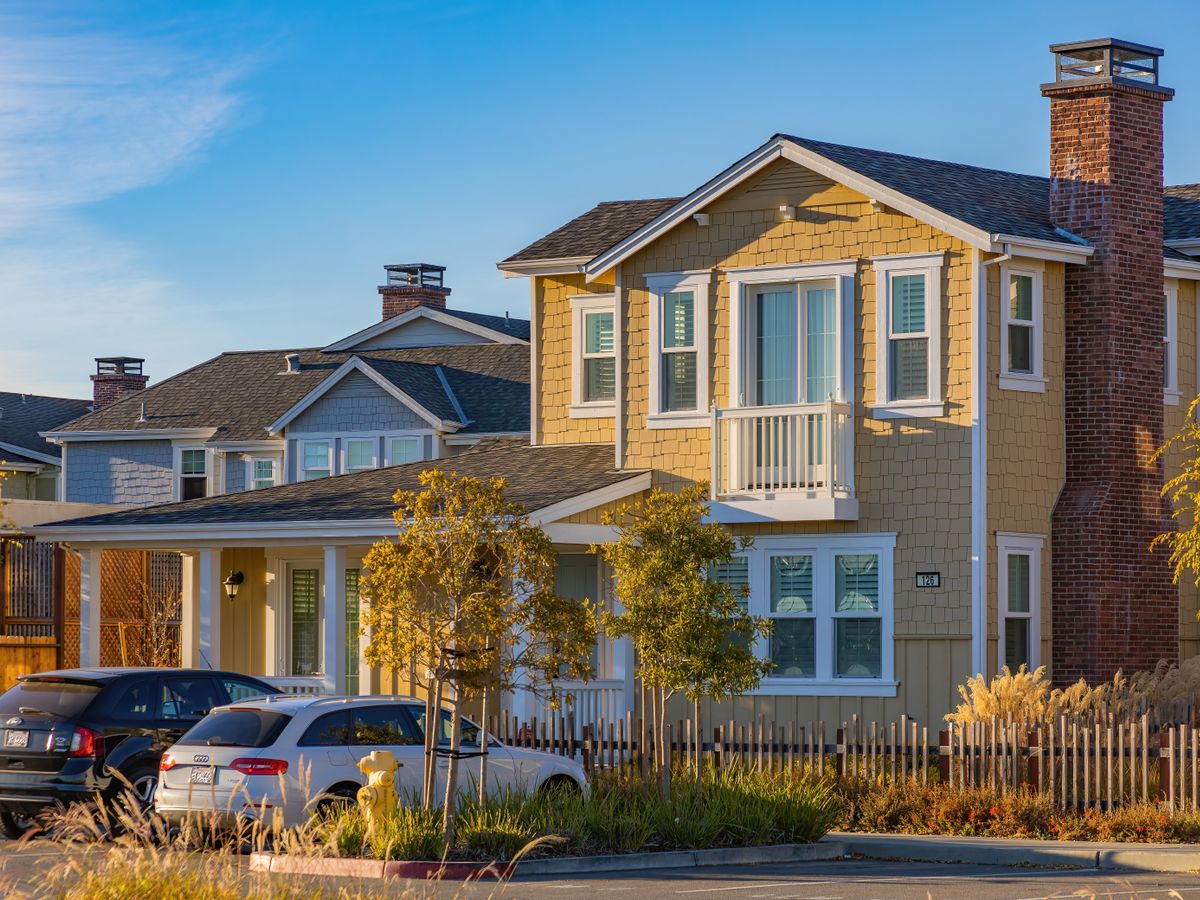 Suburban houses on a quiet residential street under a clear sky